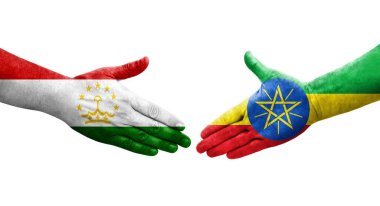Tacikistan ve Etiyopya bayrakları arasındaki el sıkışma ellerinde izole şeffaf görüntü.