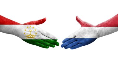 Tacikistan ve Hollanda bayrakları arasındaki el sıkışma, izole şeffaf görüntü.