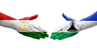 Tacikistan ve Lesotho bayrakları arasındaki el sıkışma, izole şeffaf görüntü.