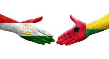 Tacikistan ve Gine Bissau bayrakları arasındaki el sıkışma, izole şeffaf görüntü.