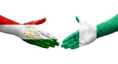 Tacikistan ve Nijerya bayrakları arasındaki el sıkışma ellerinde izole şeffaf görüntü.