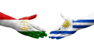 Tacikistan ve Uruguay bayrakları arasındaki el sıkışma, izole şeffaf görüntü.
