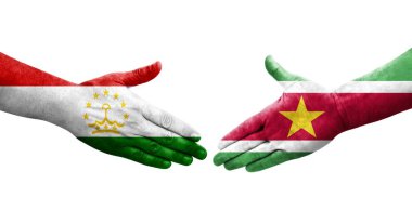 Tacikistan ve Surinam bayrakları arasındaki el sıkışma, izole şeffaf görüntü.