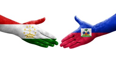 Tacikistan ve Haiti bayrakları arasındaki el sıkışma, izole şeffaf görüntü.