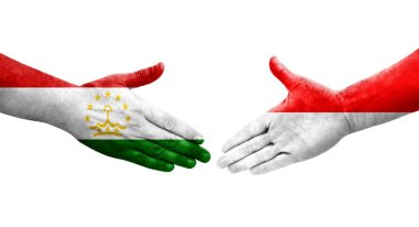 Tacikistan ve Endonezya bayrakları arasındaki el sıkışma, izole şeffaf görüntü.