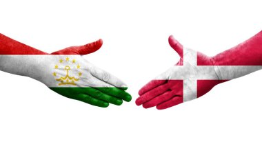 Tacikistan ve Danimarka bayrakları arasındaki el sıkışma, izole şeffaf görüntü.