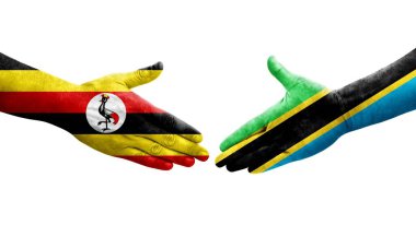 Tanzanya ve Uganda bayrakları arasındaki tokalaşma elleri boyalı, izole şeffaf görüntü.