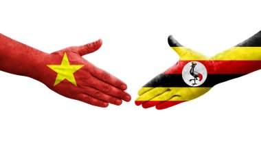 Uganda ve Vietnam bayrakları arasındaki tokalaşma ellerinde, izole edilmiş şeffaf görüntü.