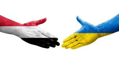 Ukrayna ve Yemen bayrakları arasındaki el sıkışma ellerinde resmedilmiş şeffaf görüntü.