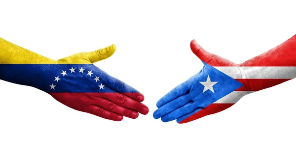 stock image Handshake between Puerto Rico and Venezuela flags painted on hands, isolated transparent image.