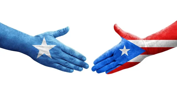 stock image Handshake between Puerto Rico and Somalia flags painted on hands, isolated transparent image.