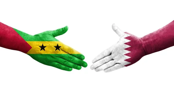 stock image Handshake between Qatar and Sao Tome and Principe flags painted on hands, isolated transparent image.