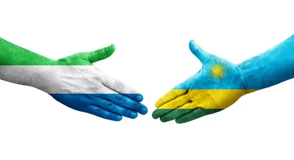 stock image Handshake between Rwanda and Sierra Leone flags painted on hands, isolated transparent image.