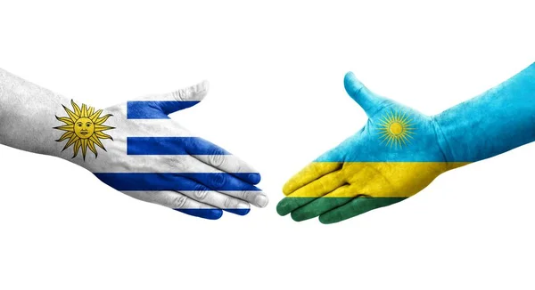 stock image Handshake between Rwanda and Uruguay flags painted on hands, isolated transparent image.