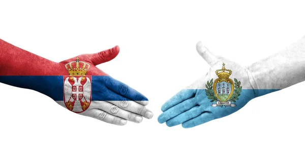 Handdruk Tussen San Marino Servië Vlaggen Geschilderd Handen Geïsoleerd Transparant — Stockfoto