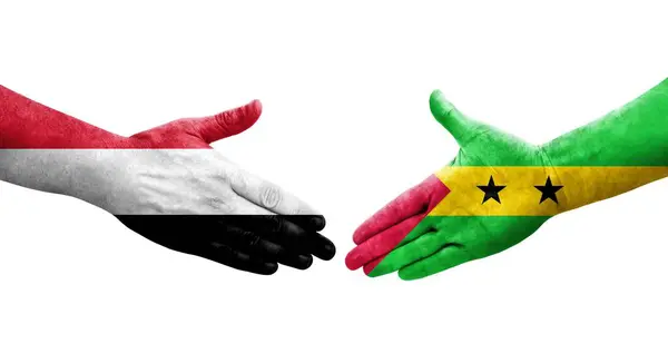 stock image Handshake between Sao Tome and Principe and Yemen flags painted on hands, isolated transparent image.