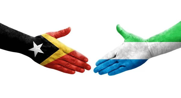 Handdruk Tussen Sierra Leone Timor Leste Vlaggen Handen Geschilderd Geïsoleerd — Stockfoto