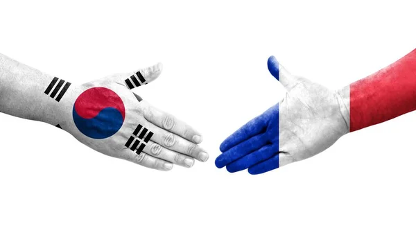 手に描かれた韓国とフランスの旗の間の握手 隔離された透明なイメージ — ストック写真