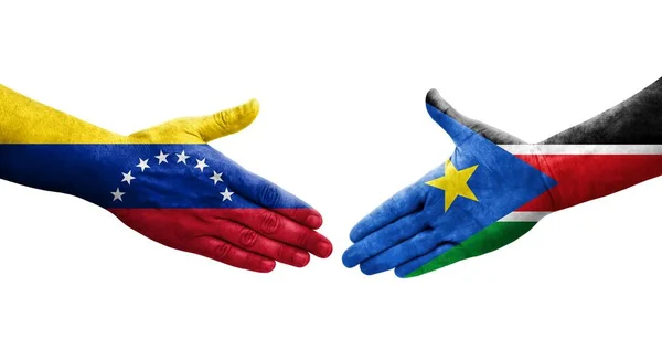 Uścisk Dłoni Między Flagami Sudanu Południowego Wenezueli Namalowanymi Rękach Odizolowany — Zdjęcie stockowe