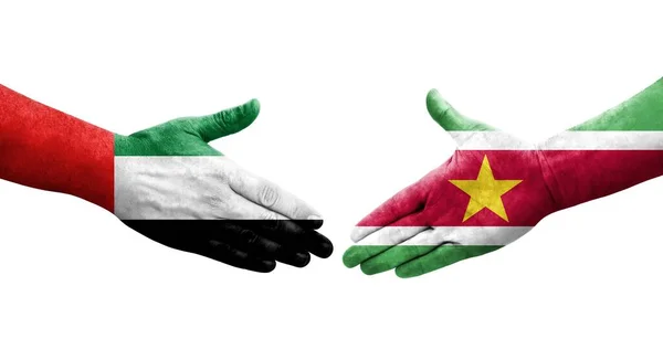 stock image Handshake between Suriname and UAE flags painted on hands, isolated transparent image.