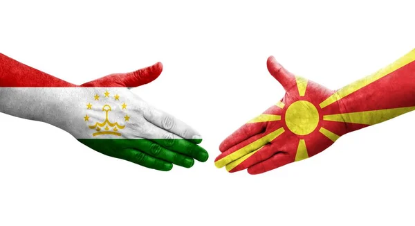 Uścisk Dłoni Między Tadżykistanem Północną Macedonią Malowane Rękach Flagi Odizolowany — Zdjęcie stockowe