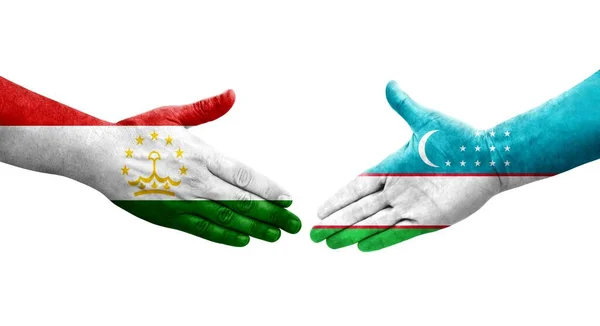 Händedruck Zwischen Tadschikistan Und Usbekistan Flaggen Auf Hände Gemalt Isoliertes — Stockfoto