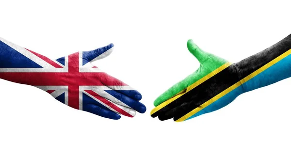 Handdruk Tussen Tanzania Het Verenigd Koninkrijk Vlaggen Geschilderd Handen Geïsoleerd — Stockfoto