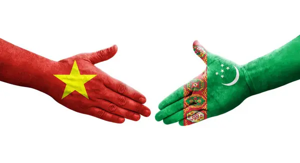 stock image Handshake between Turkmenistan and Vietnam flags painted on hands, isolated transparent image.