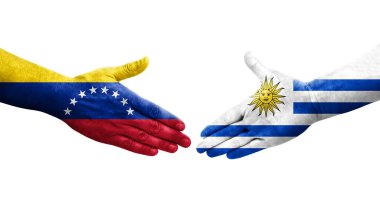 Uruguay ve Venezuela bayrakları arasındaki el sıkışma ellerinde izole şeffaf görüntü.