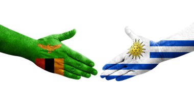 Uruguay ve Zambiya bayrakları arasındaki el sıkışma, izole şeffaf görüntü.