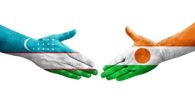 Ellerine Özbekistan ve Nijer bayrakları arasında el sıkışma, izole şeffaf görüntü.