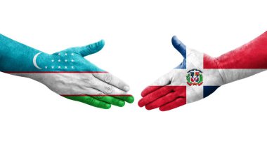 Özbekistan ile Dominik Cumhuriyeti bayrakları arasındaki el sıkışma, izole şeffaf görüntü.