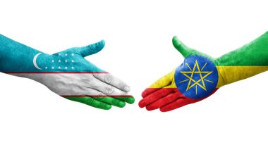 Ellere boyanmış Özbekistan ve Etiyopya bayrakları arasındaki el sıkışma, izole şeffaf görüntü.