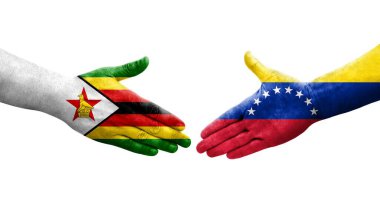 Venezuela ve Zimbabwe bayrakları arasındaki el sıkışma ellerinde izole şeffaf görüntü.