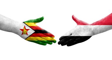 Yemen ve Zimbabwe bayrakları arasındaki el sıkışma ellerinde resmedilmiş şeffaf görüntü.