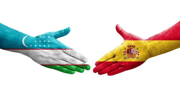 우즈베키스탄 스페인의 국기를 손으로 만지작거리면서 분리되어 이미지 — 스톡 사진