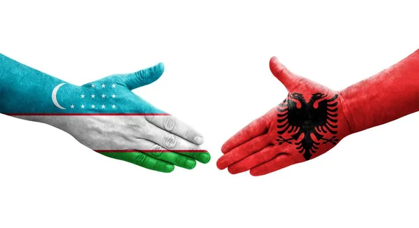 Apretón Manos Entre Uzbekistán Albania Banderas Pintadas Las Manos Imagen — Foto de Stock
