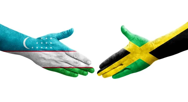 Рукопожатие Между Узбекистаном Ямайкой Нарисованными Руках Флагами Изолированное Прозрачное Изображение — стоковое фото