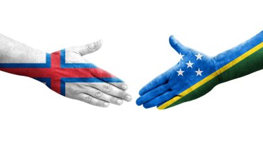 Solomon Adaları ile Faroe Adaları arasındaki el sıkışma ellerinde resmedilmiş şeffaf görüntü.