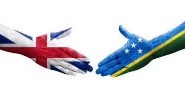 Solomon Adaları ve Büyük Britanya bayrakları arasındaki el sıkışma ellerinde resmedilmiş şeffaf görüntü.