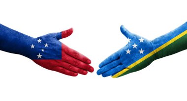 Solomon Adaları ve Samoa bayrakları arasındaki el sıkışma ellerinde izole şeffaf görüntü.