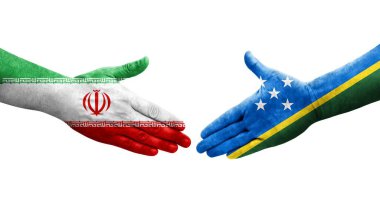 Solomon Adaları ve İran bayrakları arasındaki el sıkışma, izole edilmiş şeffaf görüntü.