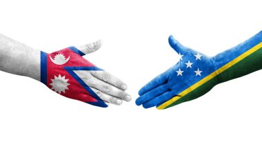 Solomon Adaları ve Nepal bayrakları arasındaki el sıkışma ellere boyanmış, izole şeffaf görüntü.