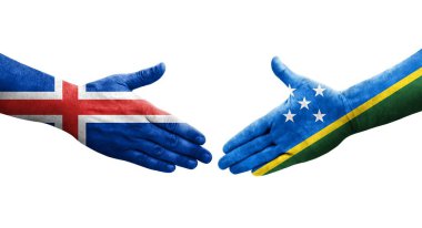 Solomon Adaları ve İzlanda bayrakları arasındaki el sıkışma, izole edilmiş şeffaf görüntü.
