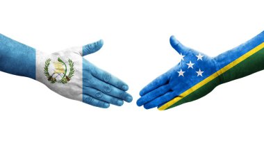 Solomon Adaları ve Guatemala bayrakları arasındaki el sıkışma ellerinde izole şeffaf görüntü.