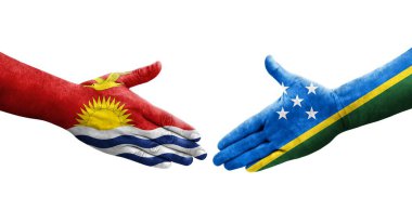 Solomon Adaları ve Kiribati bayrakları arasındaki el sıkışma ellerinde izole şeffaf görüntü.