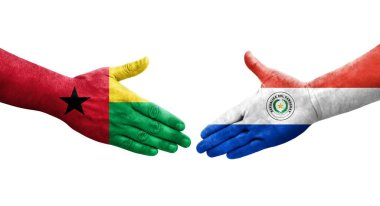 Ellerinde Paraguay ve Gine Bissau bayrakları arasında el sıkışma, izole şeffaf görüntü.