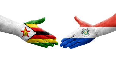 Ellerinde Paraguay ve Zimbabwe bayrakları arasında el sıkışma, izole şeffaf görüntü.