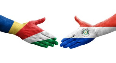 Ellerinde Paraguay ve Seyşel bayrakları arasında el sıkışma, izole şeffaf görüntü.