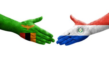 Ellerinde Paraguay ve Zambiya bayrakları arasında el sıkışma, izole şeffaf görüntü.